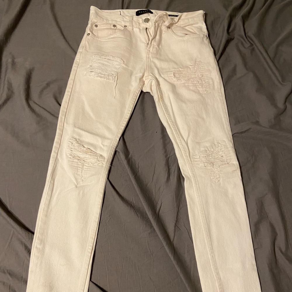 Stacked white to cream skinny jeans.